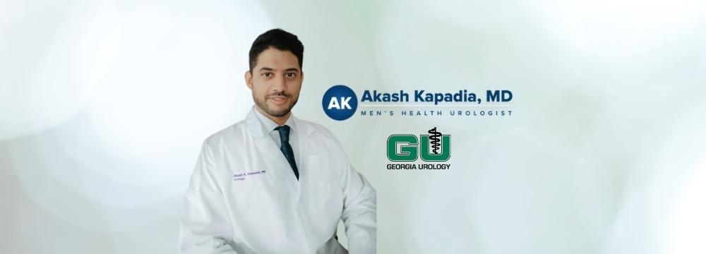 Dr.Kapadia behind green and white background with Kapadia logo and Georgia Urology logo