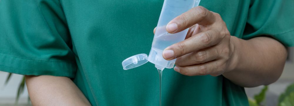 Man squeezing gel out of tube into hand