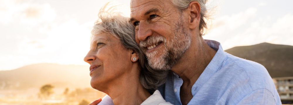 Couple embracing outdoors during sunset