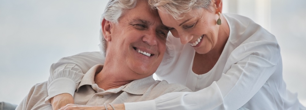 Happy couple hugging and laughing