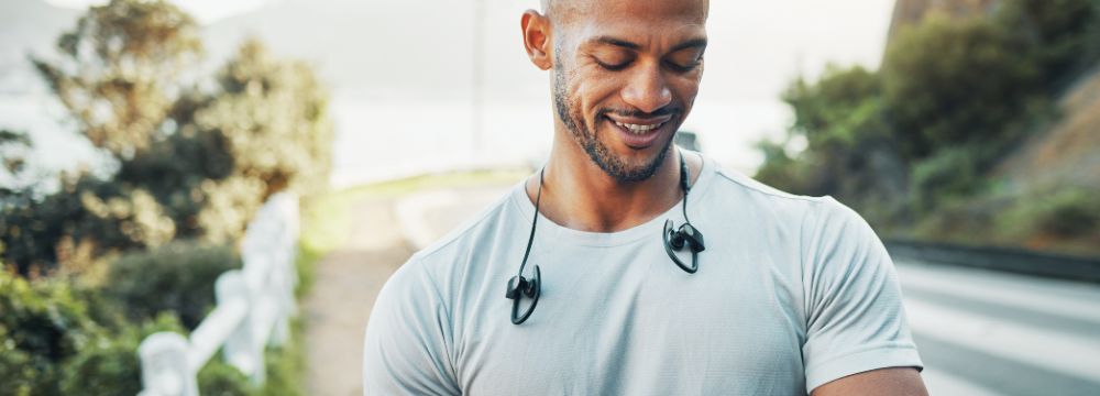 Man looking at smart watch after physical activity outdoors